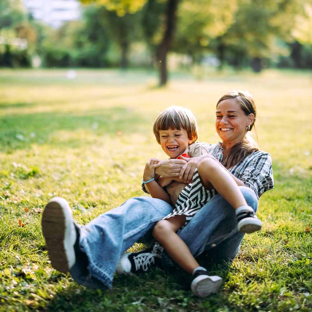 Woman playing with child in park near The Mason in Augusta, Georgia