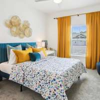 Colorful model bedroom at Avion Apartments in Jacksonville, Florida