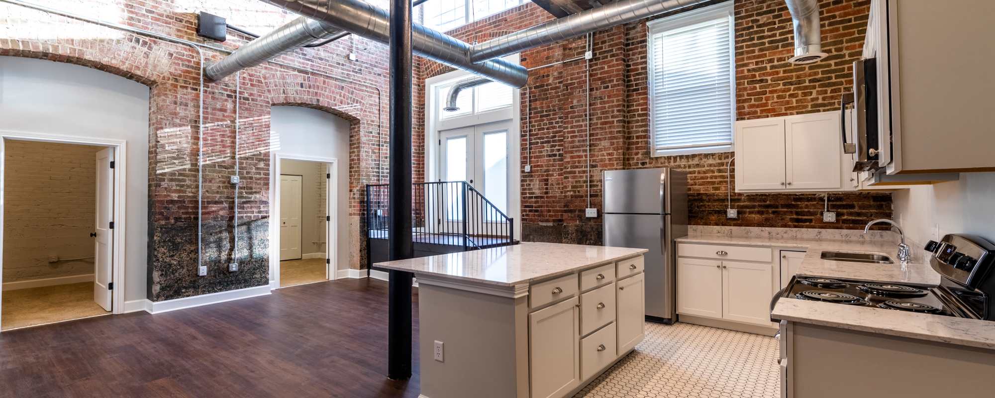 Kitchen with brick backsplash at  Buckingham and Balmoral in Indianapolis, Indiana