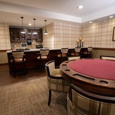 Game room with card table and bar at The Sanctuary at St. Cloud in St Cloud, Minnesota