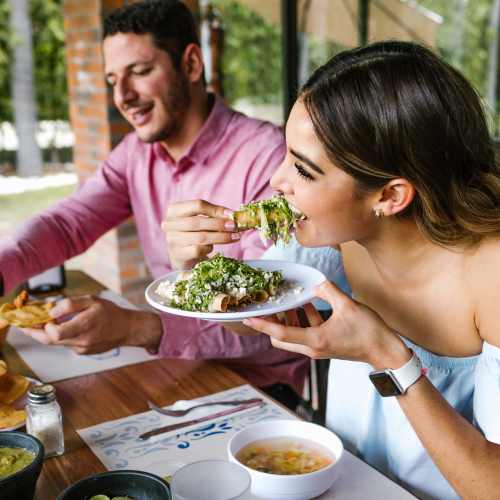 Couple having food near Parcwood Apartments in Corona, California