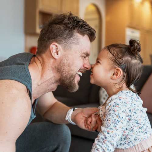 Father and child smiling at each other at Lakeview in Reno, Nevada