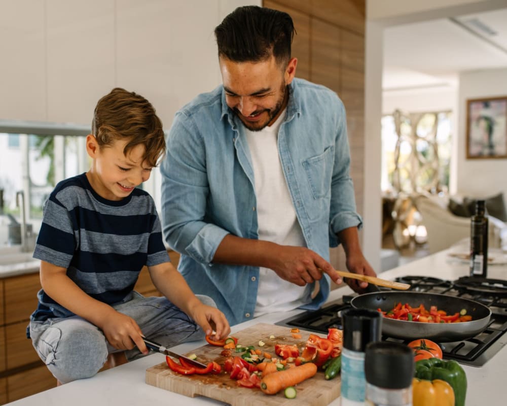 Father and son cooking in their home at Vasona Management in Campbell, California