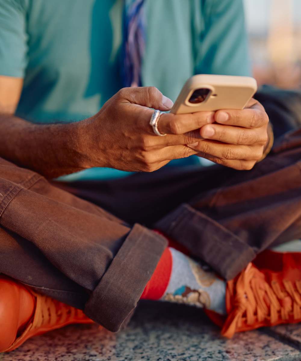 Man using his phone at ARTISAN Management Group in Des Moines, Iowa