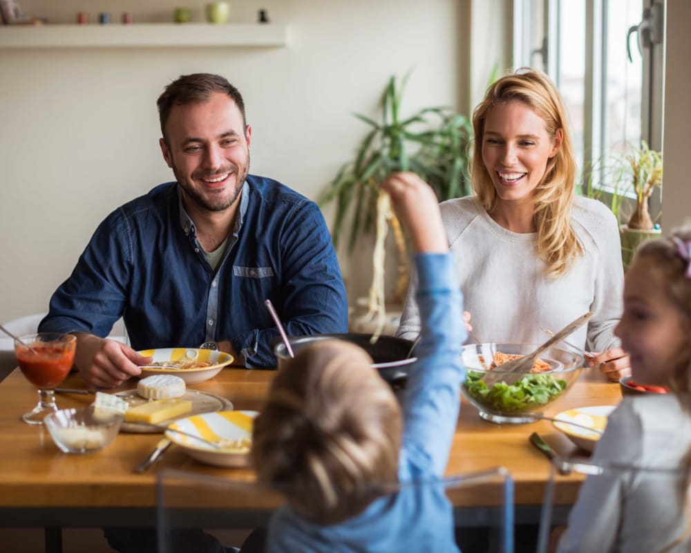 A family eating a meal at Dahlgren Townhomes in Dahlgren, Virginia