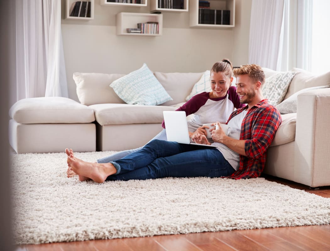 Couple sitting in their living room at Aspen Park Apartments in Wichita, Kansas
