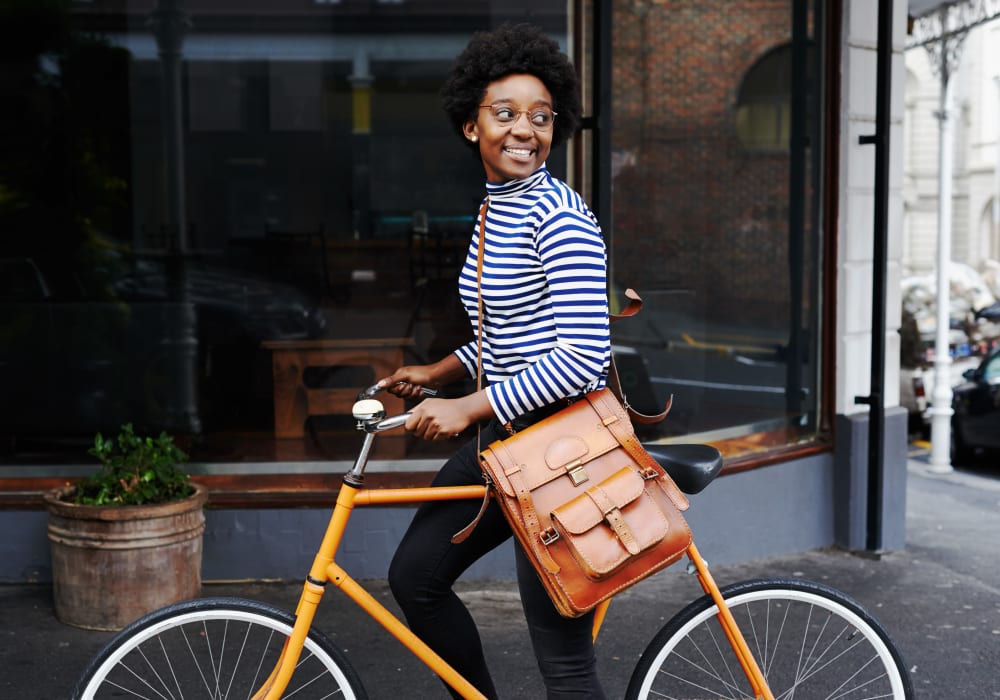 Resident riding her bike through the city near at The Marc, Palo Alto in Palo Alto, California