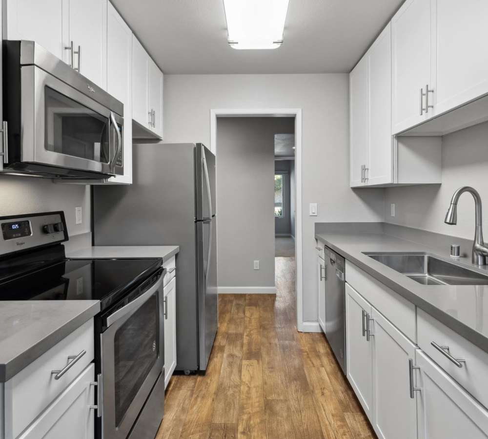 Luxury kitchen with grey quartz counters and white cabinets