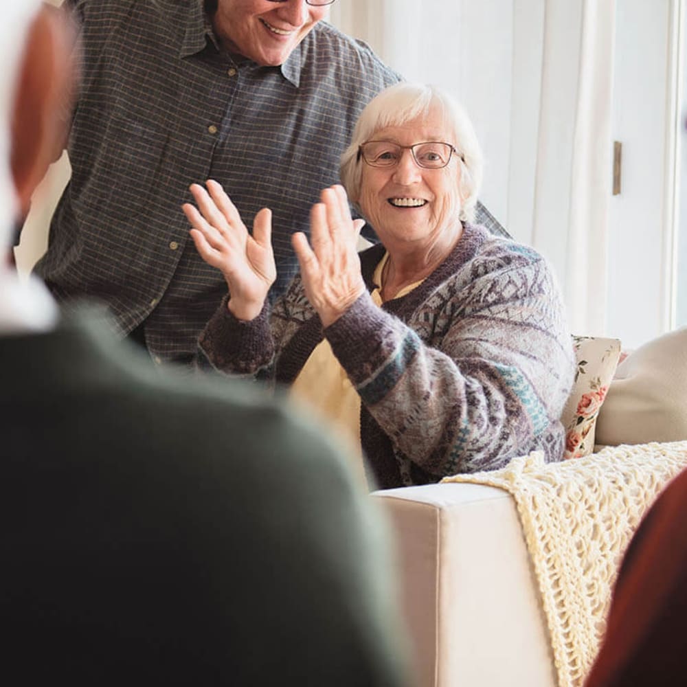 Resident laughing and clapping at Anthology of Stonebridge Ranch in McKinney, Texas