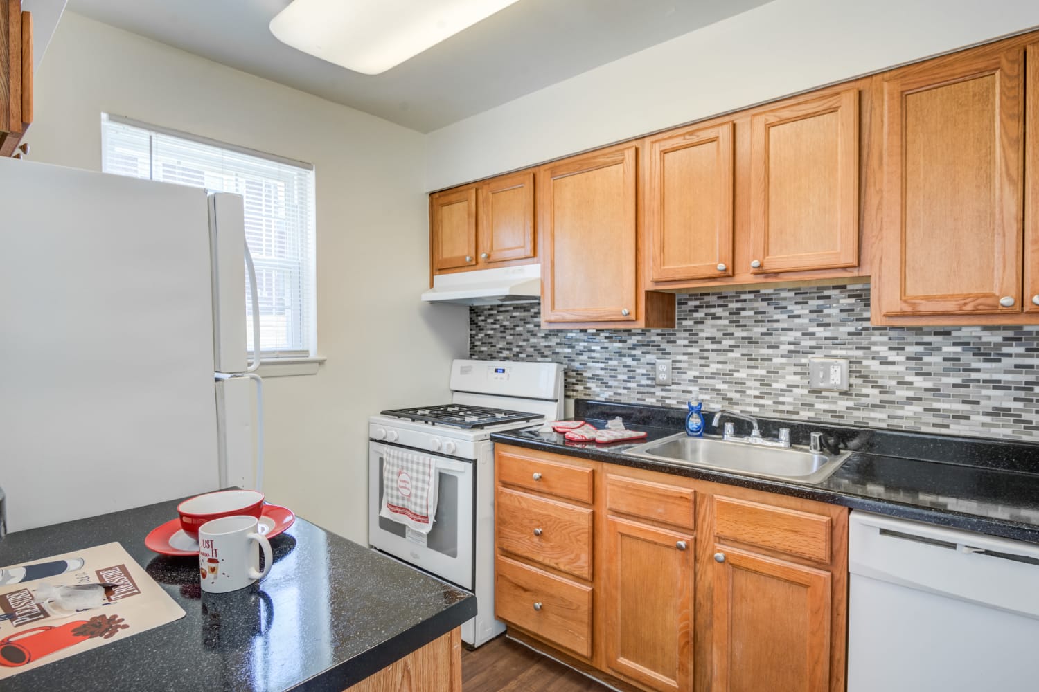 Kitchen featuring white appliances at Arbors at Edenbridge Apartments & Townhomes in Parkville, MD