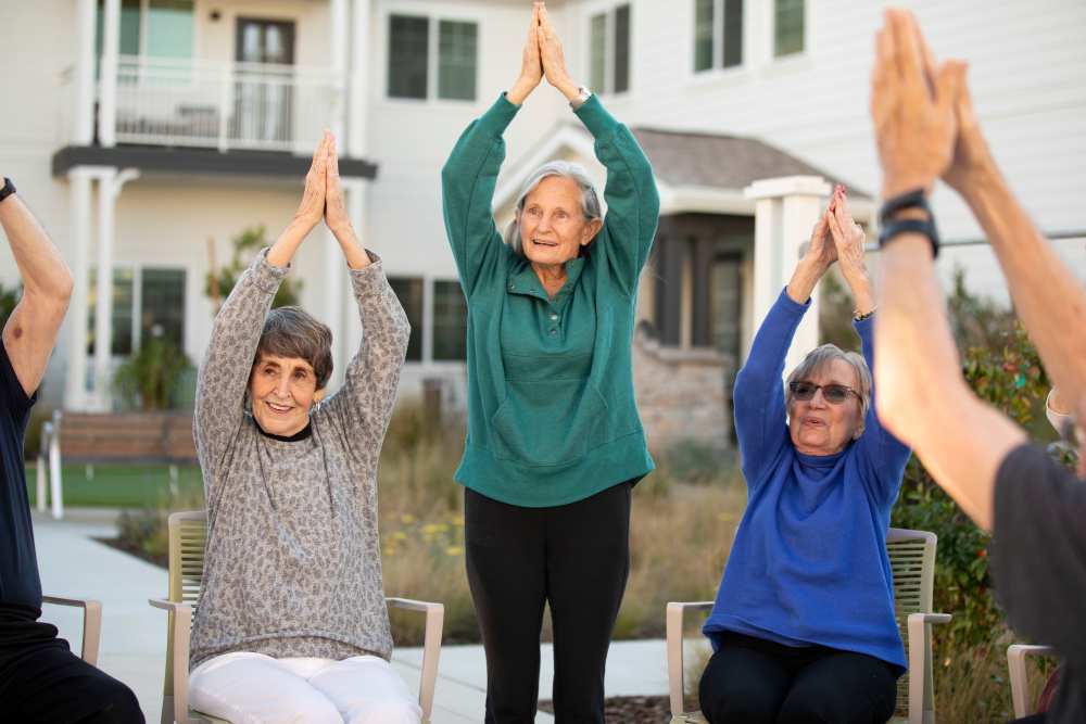 residents doing chair and standing yoga at Clearwater at The Heights in Houston, Texas