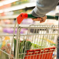 Resident shopping for grocery near Madison at Schilling Farms in Collierville, Tennessee