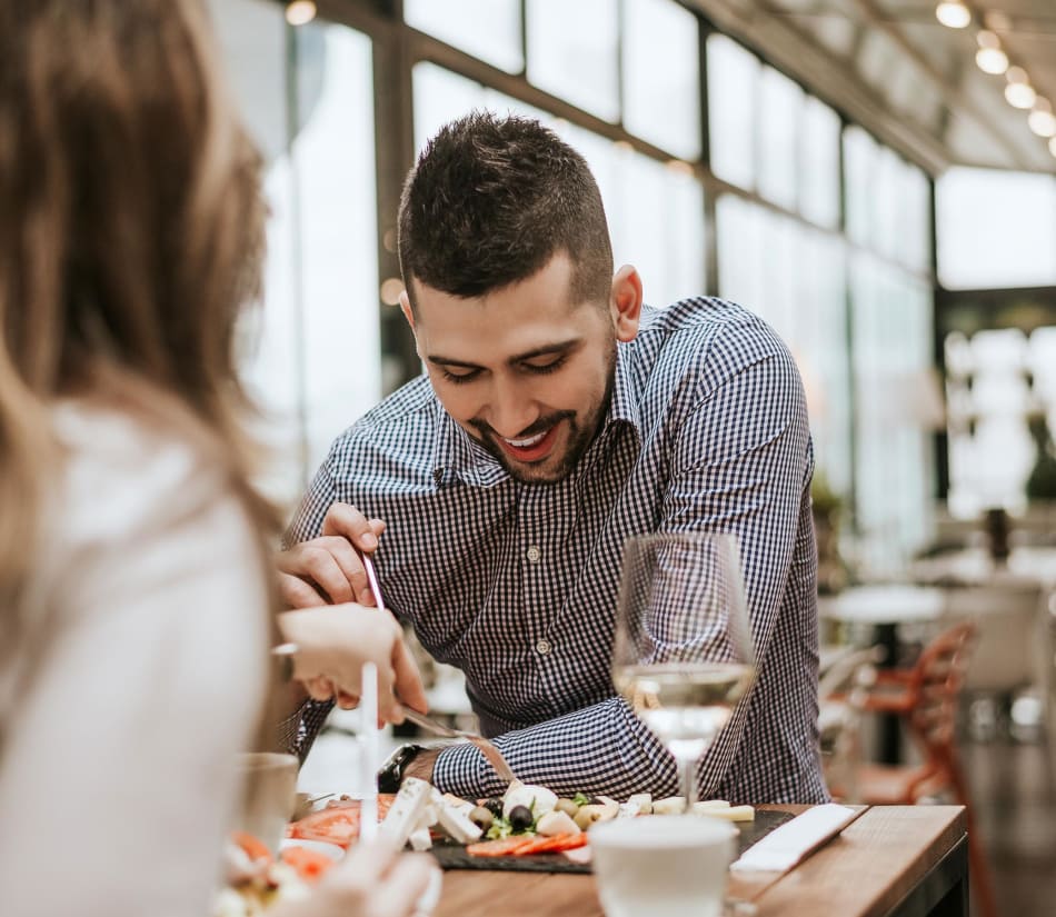 Resident grabbing a delicious meal and some wine near Sofi Lyndhurst in Lyndhurst, New Jersey