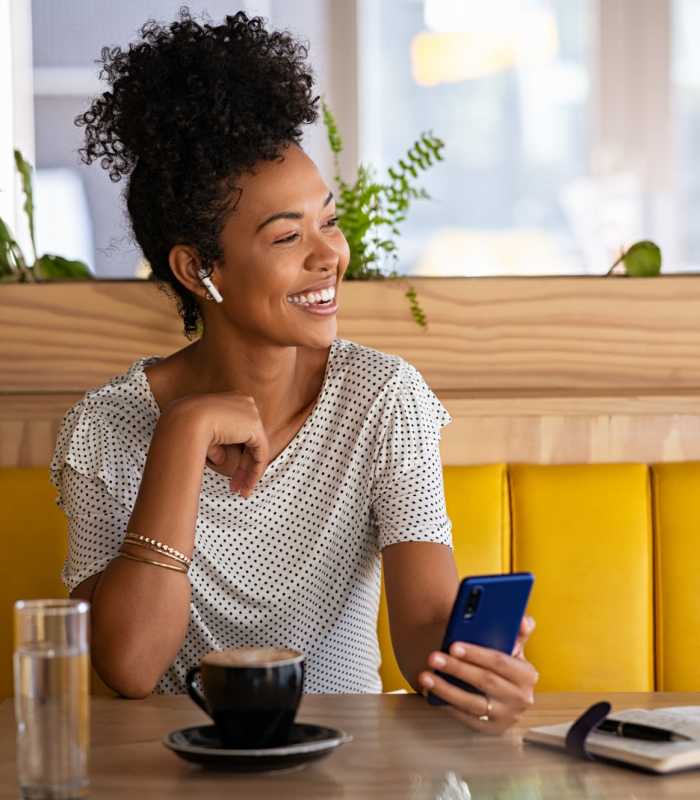 Resident using her phone at Crystal Lake Apartments in Crystal Lake, Illinois