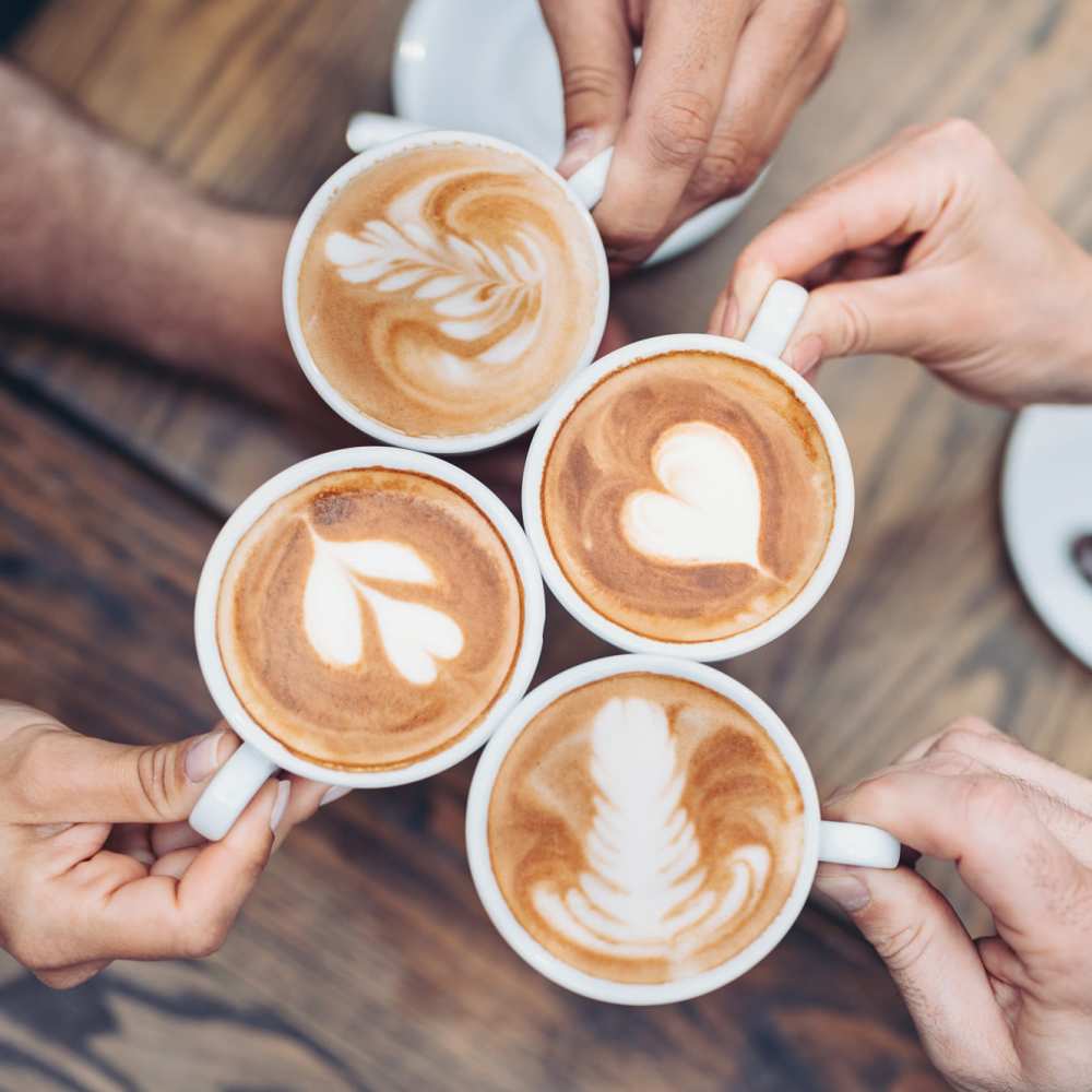 Four coffee cups with latte art at Avia Lofts at Maple Road in Amherst, New York