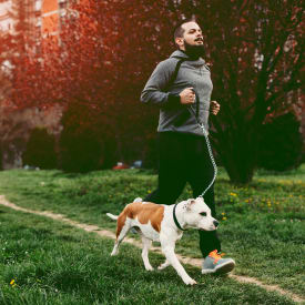 Man running with his dog in Key West near Ocean Walk Apartments