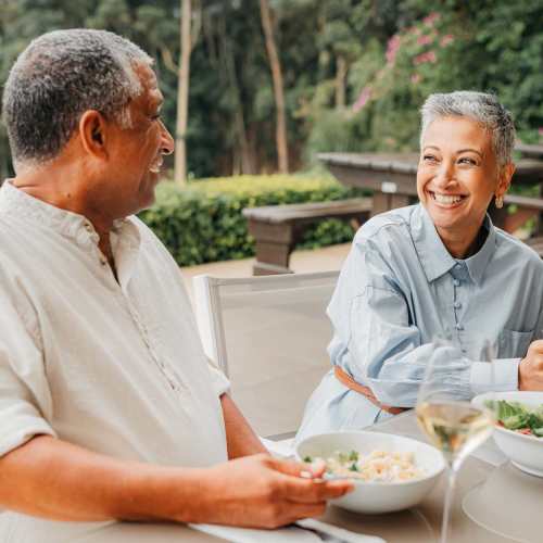 Senior resident couple enjoying a meal at the local restaurant near Bellflower Friendship Manor in Bellflower, California
