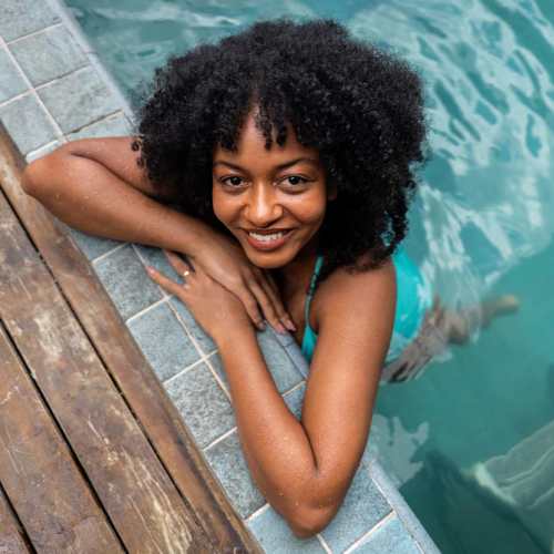 Resident posing for a photo in the swimming pool at Willow Creek Villas in Sparks, Nevada