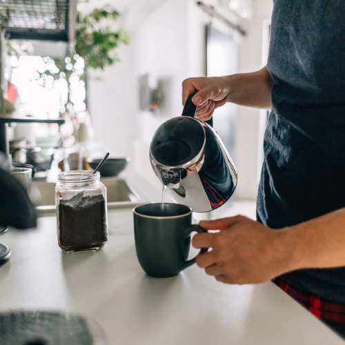 Resident making coffee in his kitchen at The Villas at Keystone Canyon in Reno, Nevada