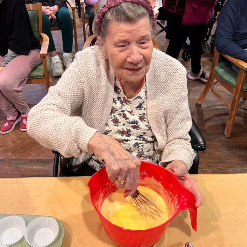Resident with a plate of desert at Oxford Glen Memory Care at Sachse in Sachse, Texas