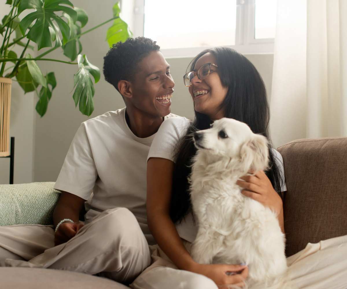 A resident couple with their pet dog at Forsythia Court Apartments in Abingdon, Maryland