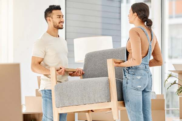 Couple moving a chair