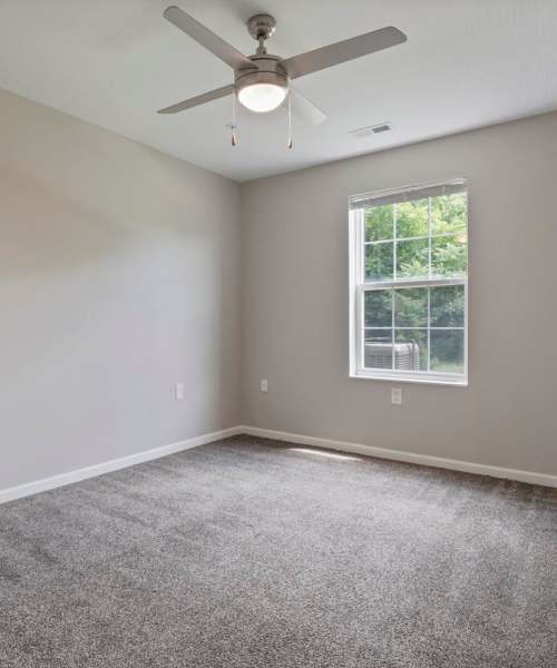 Spacious bedroom with a window pouring day light in at Wheatland Crossing II in Columbus, Ohio