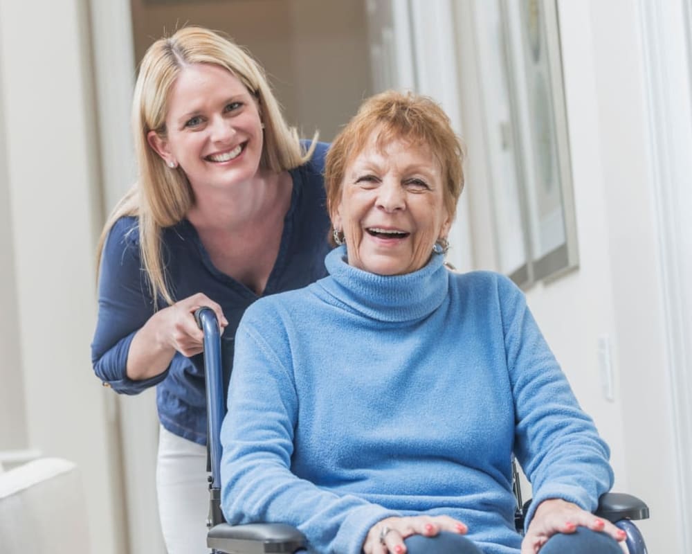 Staff with resident in assisted living apartment at Addington Place of Sparta in Sparta, Illinois.