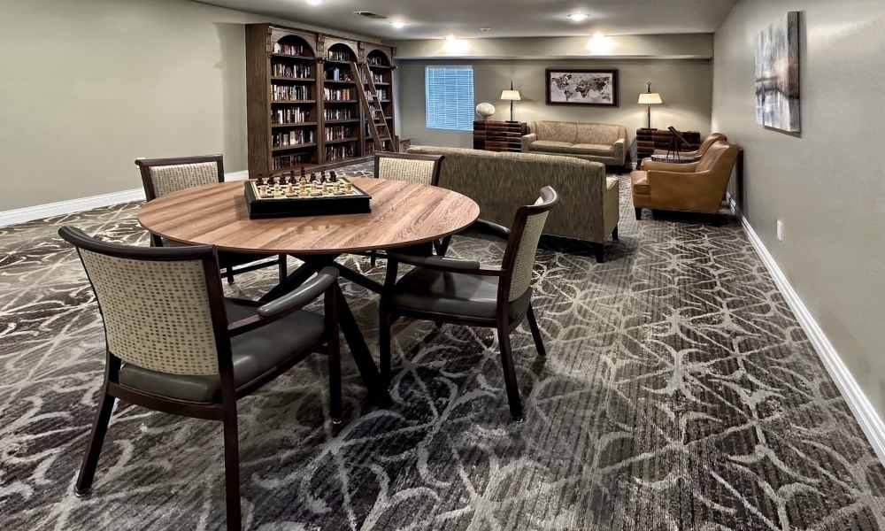 Resident library with seating at Keystone Place at Magnolia Commons in Glen Carbon, Illinois