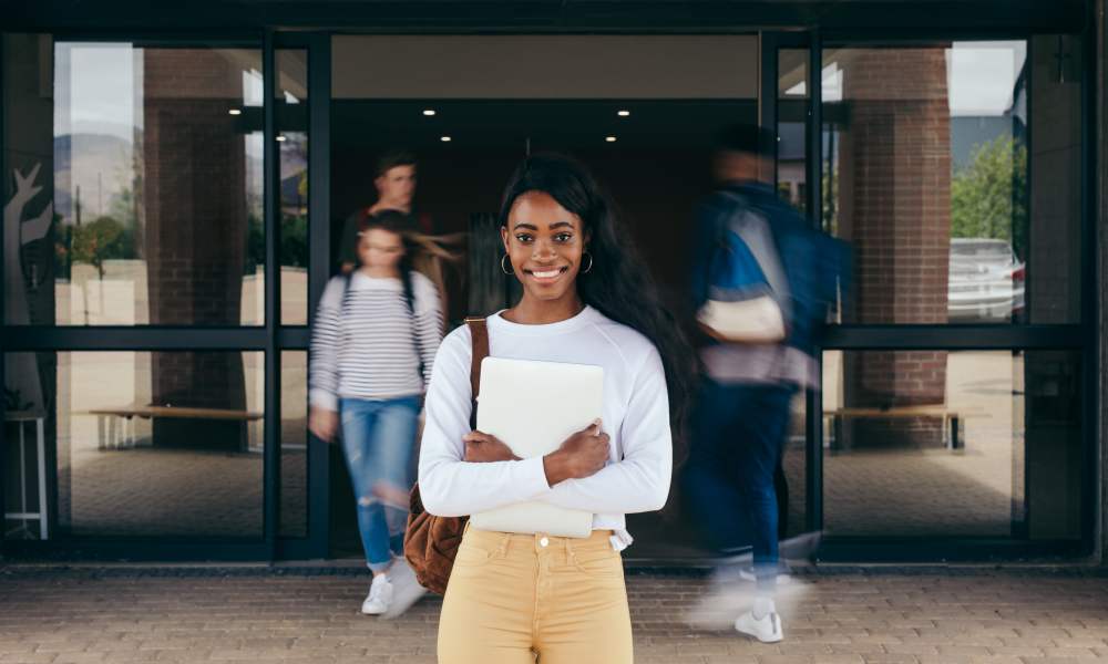 Student standing outside a university entrance near Life Tower in Houston, Texas