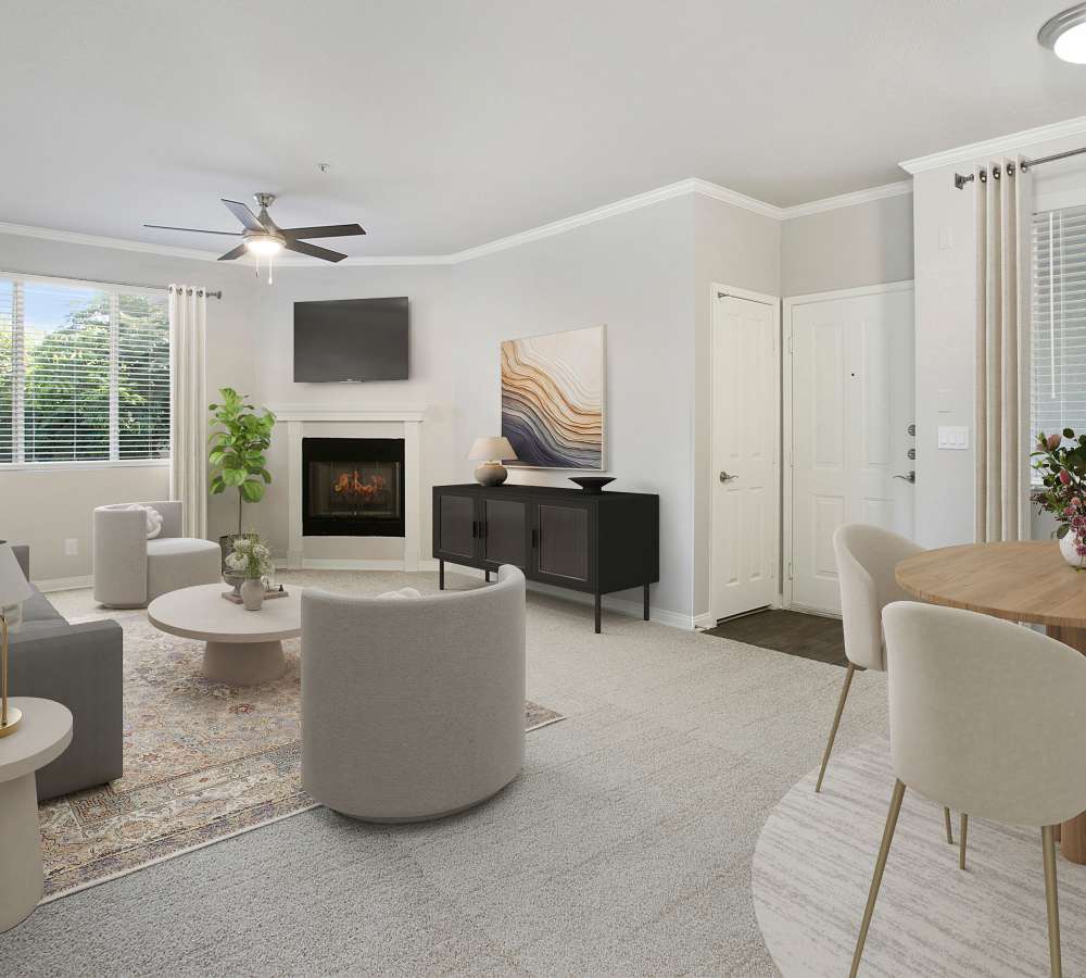 Living room with fireplace and dining area at Alicante Apartment Homes in Aliso Viejo, California