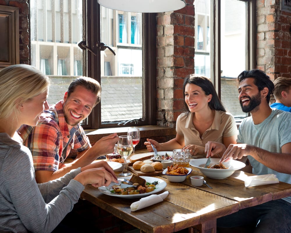 A happy residents having a meal in restaurant near Bard Estates in Port Hueneme, California