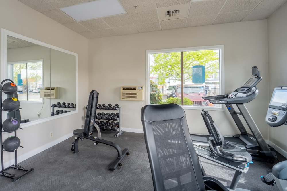 Fitness center with cardio and free weights at Thea Apartments in Tacoma, Washington