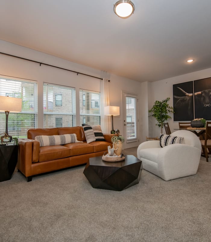 Spacious living room with large windows at Redbud Ranch Apartments in Broken Arrow, Oklahoma