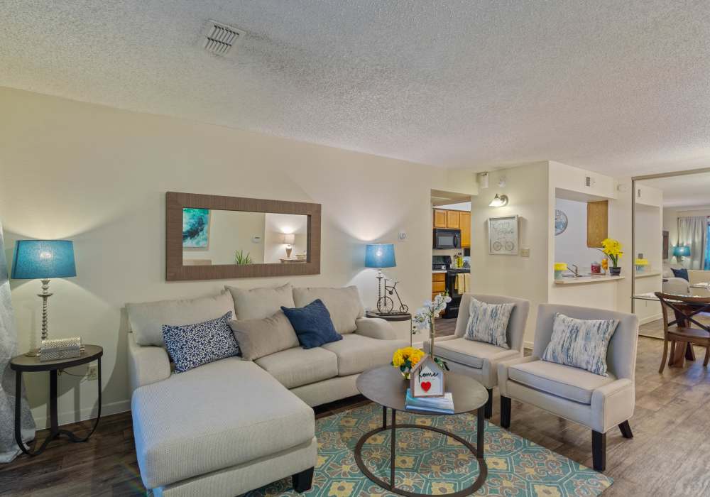 Spacious living room with wood-style flooring and stairs at Waterford Place Apartments in Mesa, Arizona, 