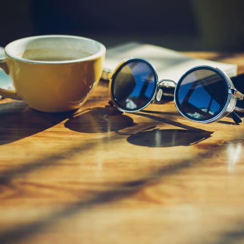 Cup of coffee and sunglasses at Tanglewood in Davis, California