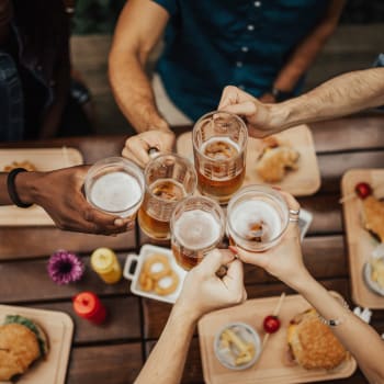 A group of friends having a drink together near Cypress Creek at Lakeline in Cedar Park, Texas