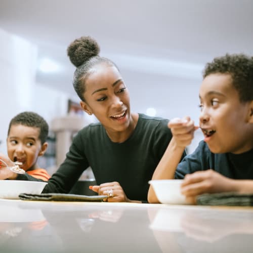 A mother feeding her children in a home at Gold Coast in Patuxent River, Maryland