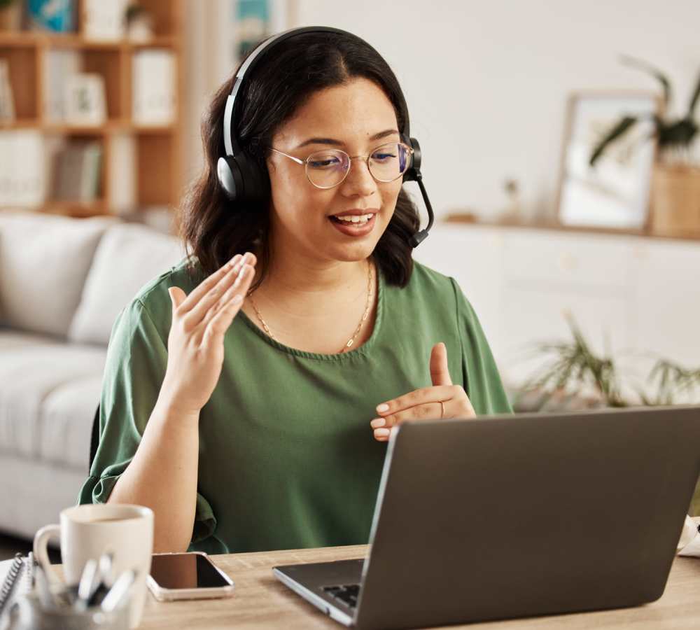 Woman wearing headset speaking to laptop at Avia Lofts at Maple Road in Amherst, New York 