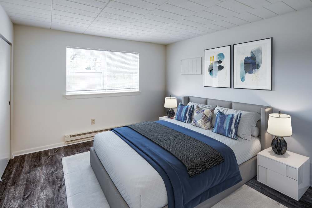 Staged bedroom with vinyl plank flooring at Presidential Arms Apartment Homes in Allison Park, Pennsylvania