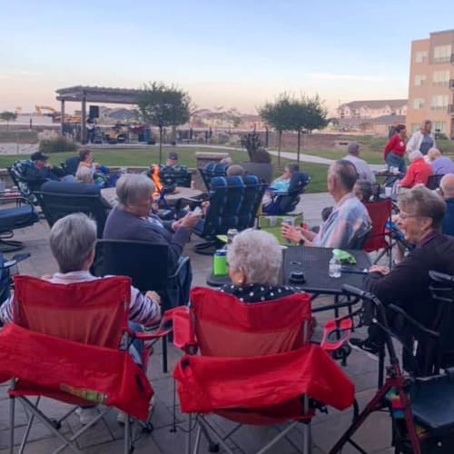 Residents enjoying the patio at  Attivo Trail Waukee in Waukee, Iowa