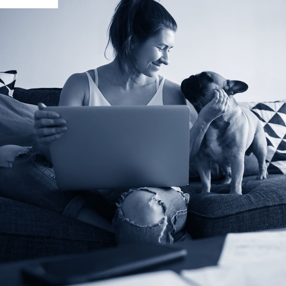 Resident studying with some help from her French bulldog at Riverside Towers Apartment Homes in New Brunswick, New Jersey