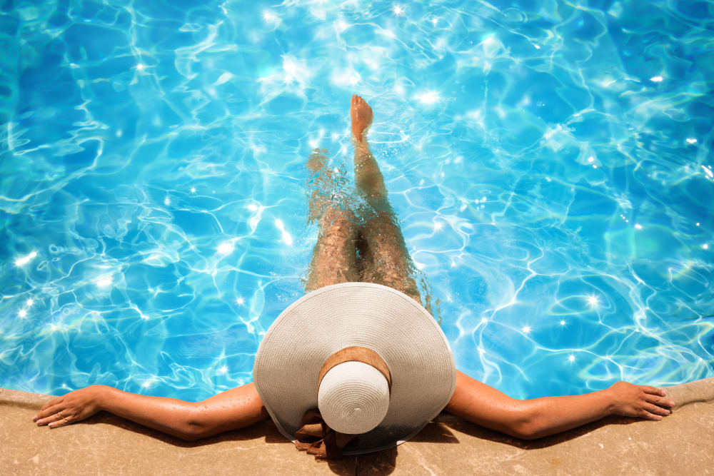 Resident floating in the swimming pool at Porter Westside in Atlanta, Georgia