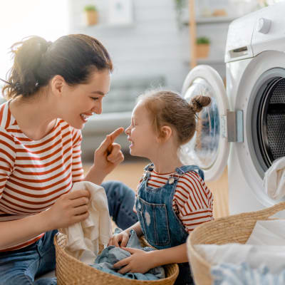 a resident doing laundry with her daughter at Westcott Hill in Joint Base Lewis-McChord, Washington