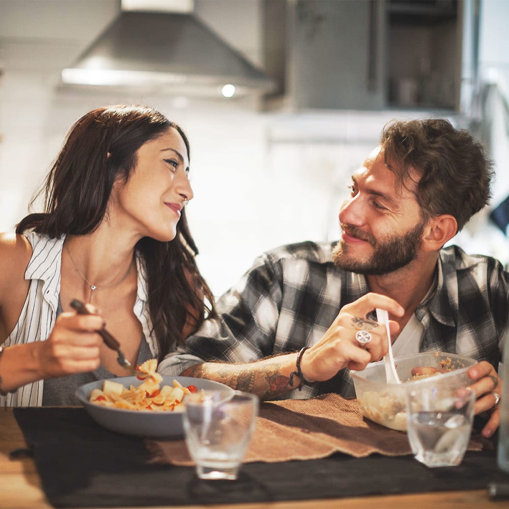 Resident couple eating dinner in their kitchen at our Sonoma Mission community at Mission Rock at Sonoma in Sonoma, California