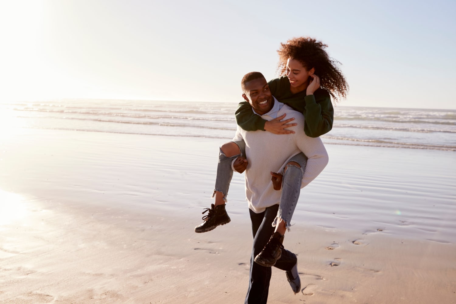 Couple walking on the beach near Glen Ellen Apartment Homes in Long Branch, New Jersey