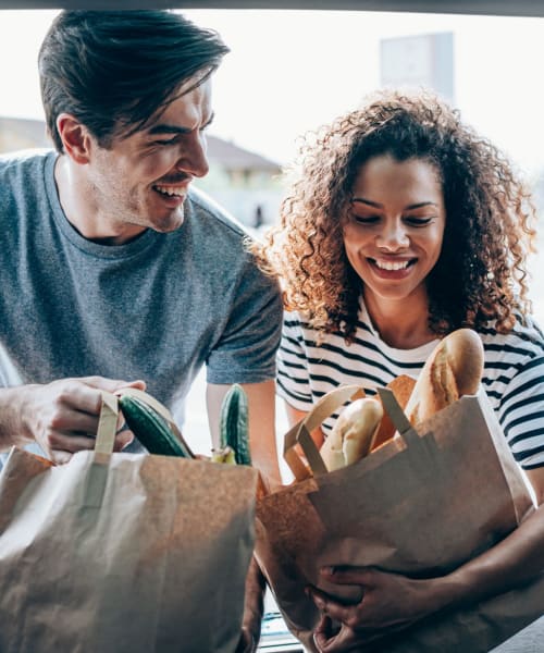 Couple unloading groceries at their home at Cobble Creek Apartment Homes in Chico, California