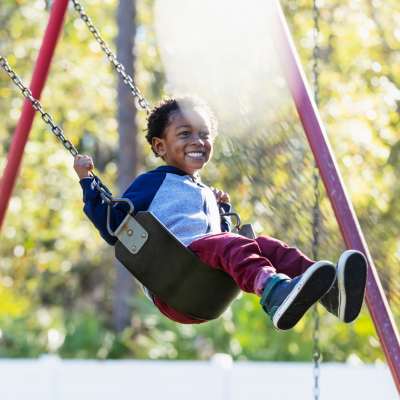 Kid swings at a playground near Monaco South in Denver, Colorado