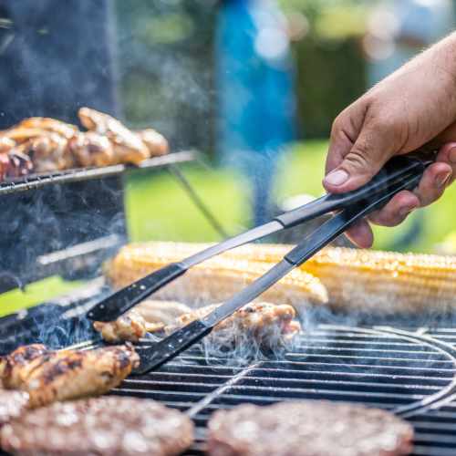 Grilling meat and corn outdoors at A.L. Miller Village in Macon, Georgia