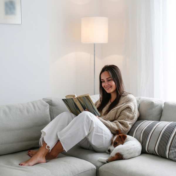 Resident reading book in the living room at Canyon House in New Braunfels, Texas